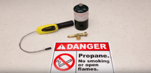 Danger sign in front of R290 refrigerant - How to Repair a True Refrigeration Cabinet with R290