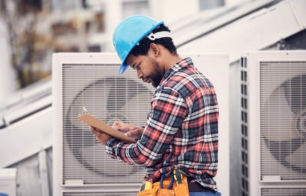 HVAC technican reviewing his checklist - The ultimate HVAC maintenance checklist for techs